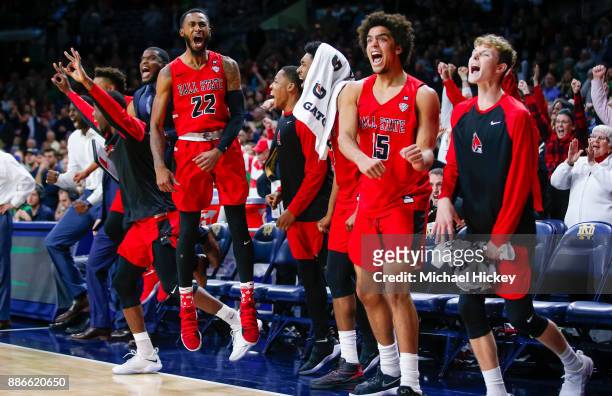 Members of the Ball State Cardinals celebrate in the closing seconds after defeating the Notre Dame Fighting Irish at Purcell Pavilion on December 5,...