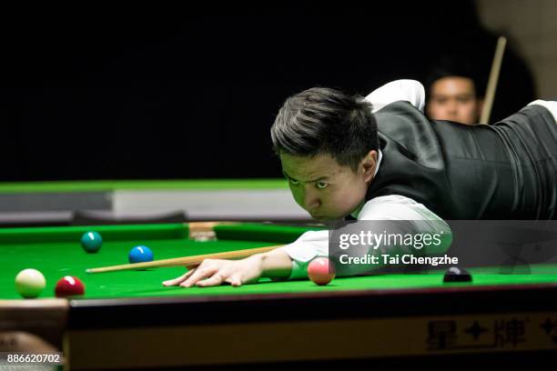 Xiao Guodong of China plays a shot during his third round match against Noppon Saengkham of Thailand on day 9 of 2017 Betway UK Championship at...