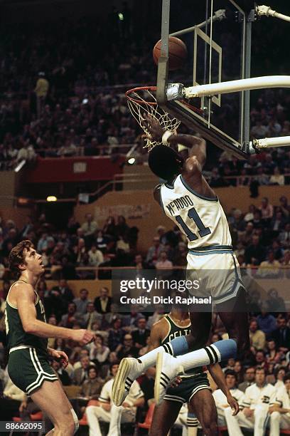 Bob McAdoo of the Buffalo Braves shoots a layup against the Boston Celtics during a game played in 1974 at the Buffalo Memorial Auditorium in...