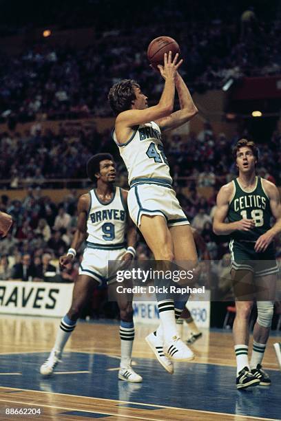 Jack Marin of the Buffalo Braves goes up for a shot against the Boston Celtics during a game played in 1974 at the Buffalo Memorial Auditorium in...