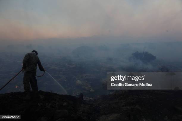 Jarrald Ingram hits hot spots where embers from the Creek Fire were threatening homes along along Bengal Street in Sunland on December 5, 2017....