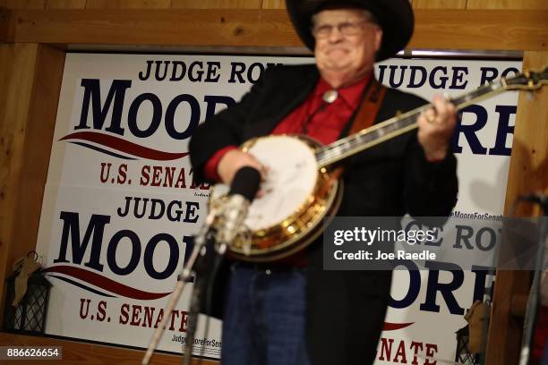 Banjo player is seen in front of campaign posters during a rally for Republican Senatorial candidate Roy Moore at Oak Hollow Farm on December 5, 2017...