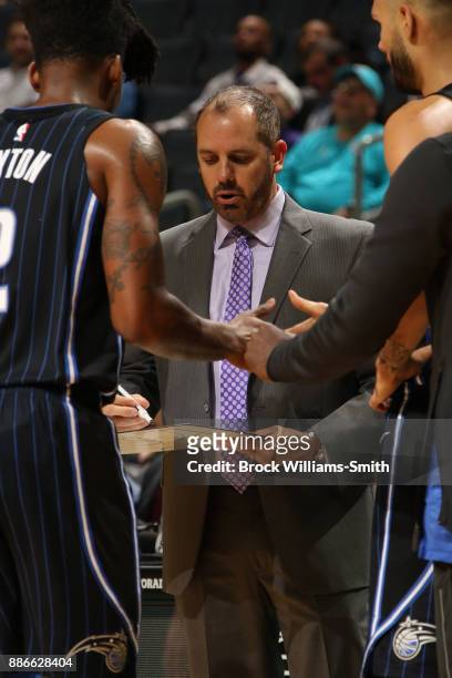 Frank Vogel of the Orlando Magic speaks with team during game against the Charlotte Hornets on December 4, 2017 at Spectrum Center in Charlotte,...