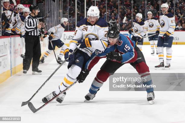 Duncan Siemens of the Colorado Avalanche defends against Hudson Fasching of the Buffalo Sabres at the Pepsi Center on December 5, 2017 in Denver,...