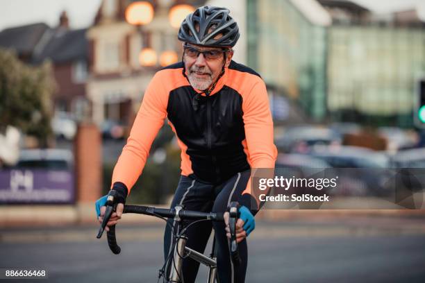 a senior man on his racing bike - cycling uk stock pictures, royalty-free photos & images