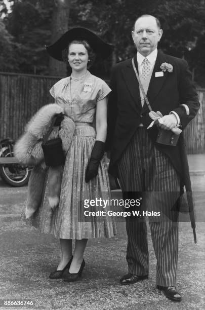 Sir Denys Lowson, former Lord Mayor of London, with Lady Lowson at the first day of Royal Ascot, UK, 17th June 1952.