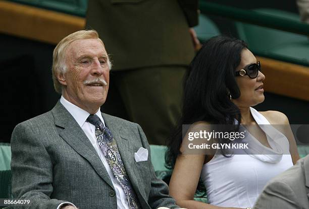 British television entertainer Bruce Forsyth watches a game between Russia's Maria Sharapova and Argentina's Gisela Dulko on Centre Court at the All...