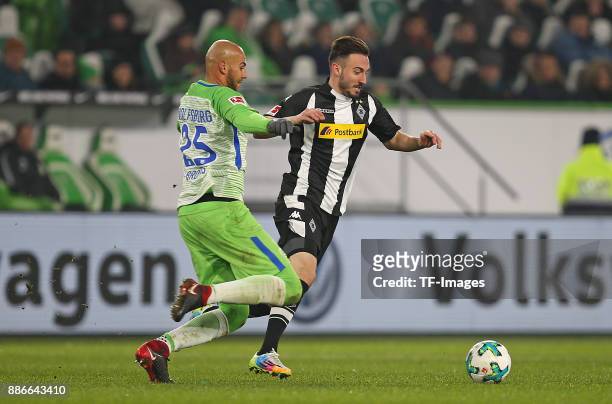 John Anthony Brooks of Wolfsburg and Josip Drmic of Borussia Moenchengladbach battle for the ball during the Bundesliga match between VfL Wolfsburg...