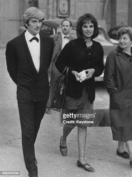 American actor John Drew Barrymore walking in the studio gardens with actress Antonella Lualdi during the filming of 'Sexy Party' (later titled...