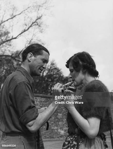 Henry Thynne, 6th Marquess of Bath and his wife the Marchioness enjoy a cigarette after showing the public around their home, Longleat House in...