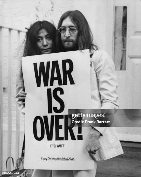 Singer and songwriter John Lennon , formerly of English rock band the Beatles, and his wife Yoko Ono pose on the steps of the Apple building in...