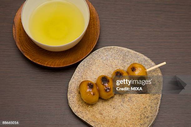 skewered dumpling with japanese green tea - brown sauce stock pictures, royalty-free photos & images