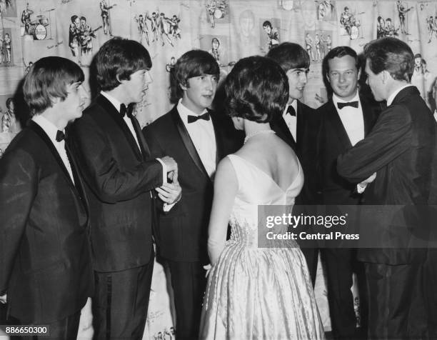 Princess Margaret and the Earl of Snowdon meet British rock group the Beatles at the world premiere of their film 'A Hard Day's Night' at the London...