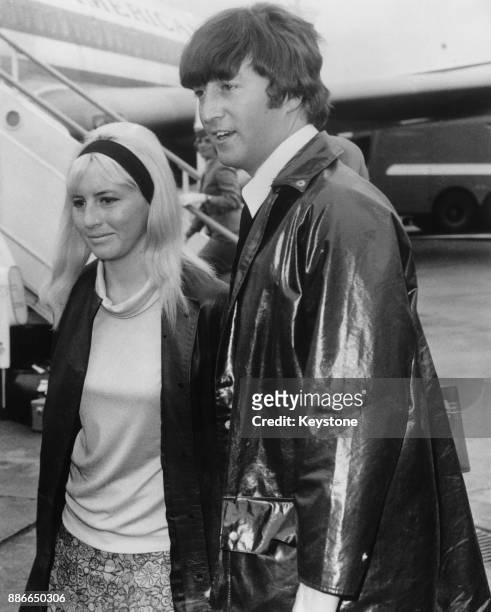 Musician, singer and songwriter John Lennon of British rock group the Beatles and his first wife Cynthia arrive home at London Airport after a...