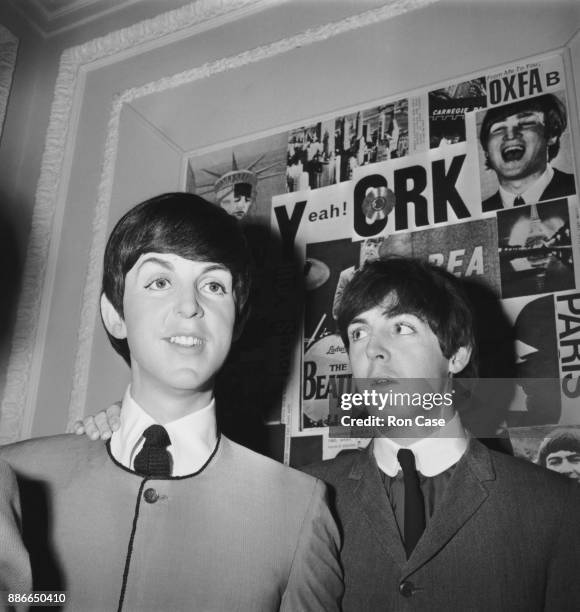 Musician and singer Paul McCartney of British rock group the Beatles poses with a waxwork effigy of himself at Madame Tussauds in London, 29th April...