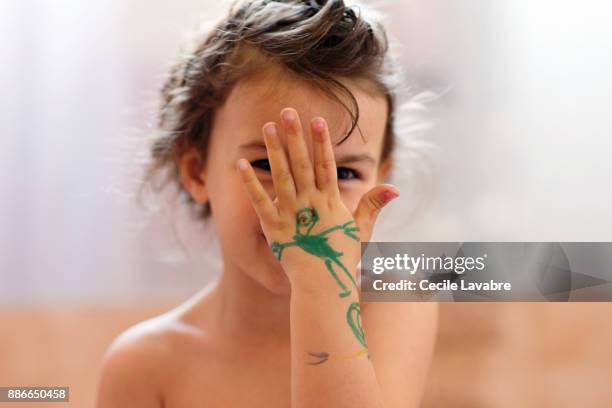 little girl showing her drawing on hand - stick figure arms raised stock pictures, royalty-free photos & images