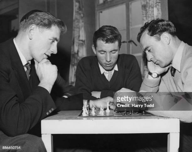 From left to right, Portsmouth footballers Fred Brown , Willie Morrison and Ron Saunders relax with a game of chess at their hotel in Saltdean, UK,...