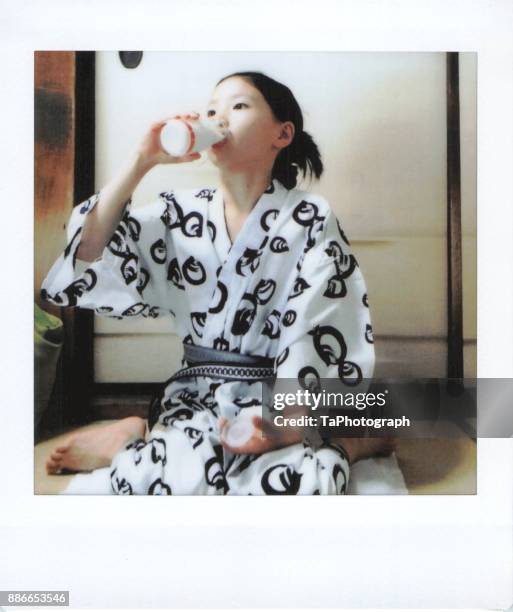 girl drinking milk in a kimono - 銭湯 ストックフォトと画像