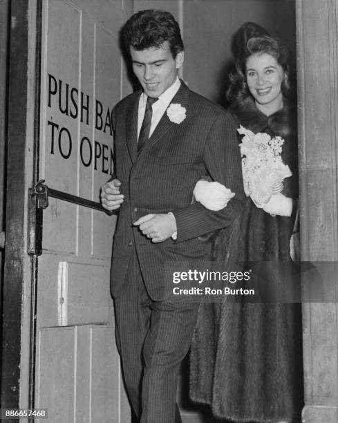 German actor Horst Buchholz leaves Caxton Hall in London with his new wife, French actress Myriam Bru, after their wedding, 7th December 1958.