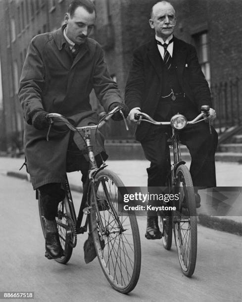 Alderman Alfie Byrne , the former Lord Mayor of Dublin, cycles to Leinster House in Dublin with his son, politician Alfred P. Byrne for a meeting of...