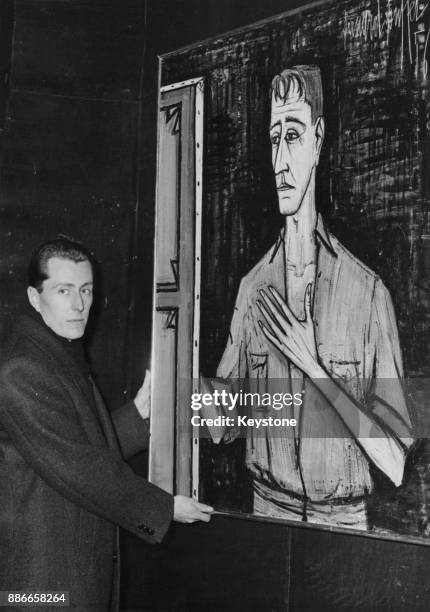 French Expressionist painter Bernard Buffet with a 1956 self-portrait at a gallery in the Rue de Faubourg Saint-Honoré, Paris, France, 17th January...