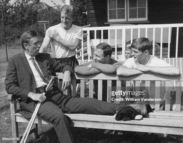 Vic Buckingham , manager of Fulham F.C., talks to Fulham players Terry Dyson, George Cohen and Allan Clarke after a training session at a ground in...