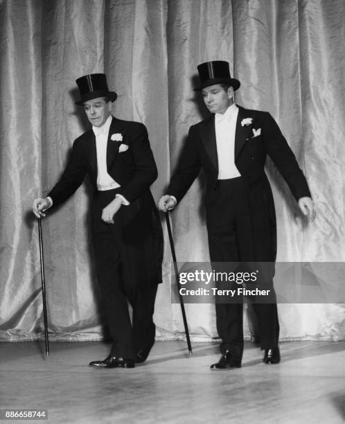Scottish actor Jack Buchanan tap dancing with Sir Laurence Olivier during rehearsals for the charity show 'Midnight Cavalcade' at the London...