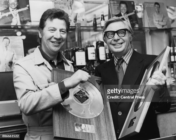 English singer Max Bygraves with musical director Cyril Stapleton and two of the golden discs presented to him at ATV House in London, to mark the...
