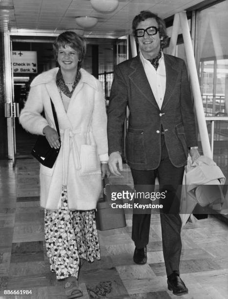 English actor Michael Caine arrives at Heathrow Airport with his daughter Dominique, en route to attend the Oscars in Hollywood, 21st March 1973.