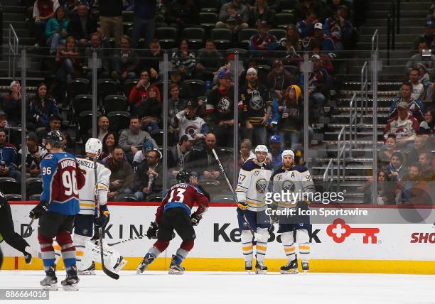 Buffalo Sabres center Ryan O'Reilly and Buffalo Sabres left wing Benoit Pouliot celebrate a goal by Pouliot during a regular season game between the...