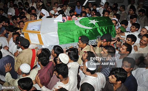 Troops, family members and residents carry the coffin of Pakistan�s army Major Hafiz Atiq, who was killed in the ongoing operation against Taliban...