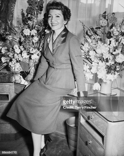 American actress Claudette Colbert at Claridge's, having just arrived in London to star in the film 'White Blood', aka 'Outpost in Malaya', 4th March...