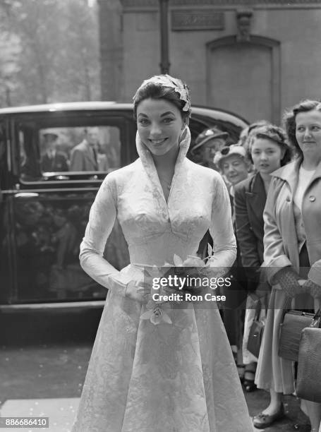 English actress Joan Collins arrives at Caxton Hall in London for her wedding to actor Maxwell Reed, 24th May 1952.