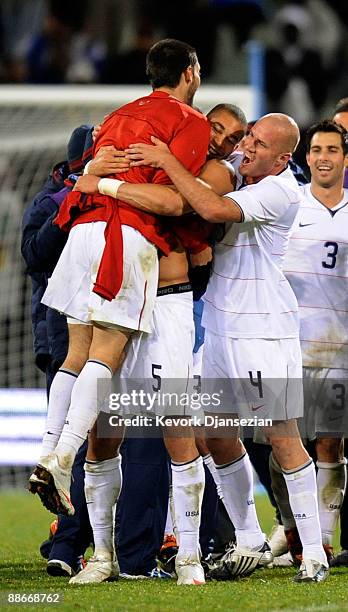 Clint Dempsey of USA celebrate with Oguchi Onyewu, Carlos Bocanegra and Conor Casey after an upset win, 2-0, over Spain during the FIFA...