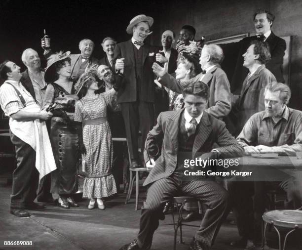 Ensemble scene from a performance of Eugene O'Neill's 'The Iceman Cometh,' Martin Beck Theatre, New York, 1946. Actor James Barton stands on a chair...