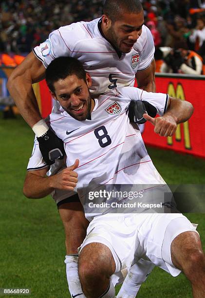 Clint Dempsey of the USA celebrates the second goal with Oguchi Onyewu during the FIFA Confederations Cup Semi Final match between Spain and USA at...