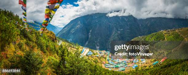 prayer flags flying over namche bazaar sherpa village himalayas nepal - namche bazaar stock pictures, royalty-free photos & images