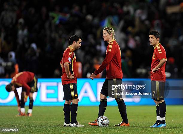 Fernando Torres of Spain trudges past his teammates David Villa and Xavi Hernandez after conceding the 2:0 goal during the FIFA Confederations Cup...