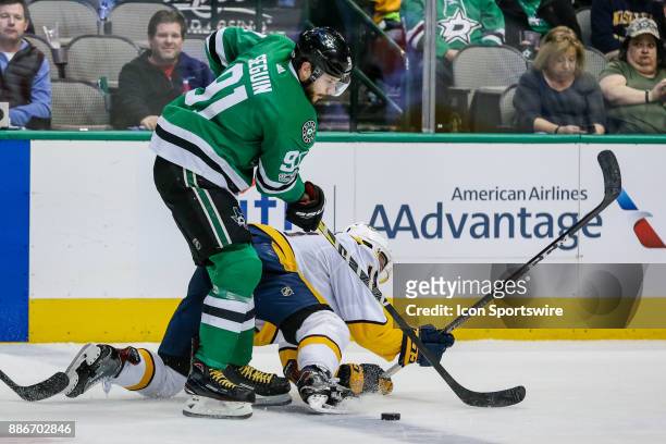 Dallas Stars center Tyler Seguin gets tied up with Nashville Predators center Kyle Turris during a face-off during the game between the Dallas Stars...