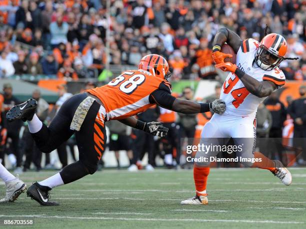 Running back Isaiah Crowell of the Cleveland Browns breaks the tackle of linebacker Carl Lawson of the Cincinnati Bengals in the fourth quarter of a...