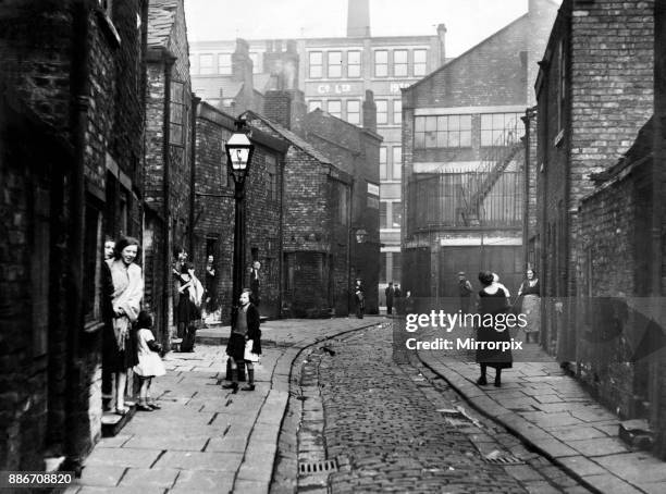 An unnamed street in Salford's Greengate area. This is typical of the living conditions of the early thirties. At the time of this photograph the...