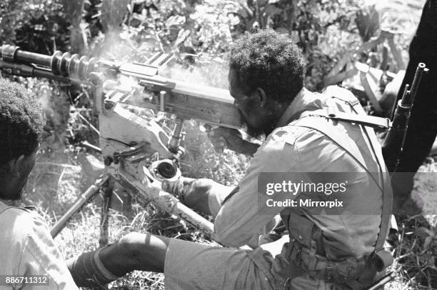 Abyssinian War September 1935 Abyssinian machine gunner firing an old Hotchkiss machine gun on the Ogadan front during the Italian invasion of...