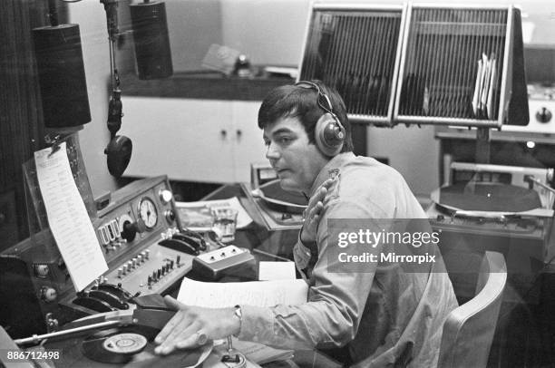 Tony Blackburn, the 22 year old Disc Jockey, during his broadcast of the very first show on BBC Radio One. Here Tony queues up the first disc he will...