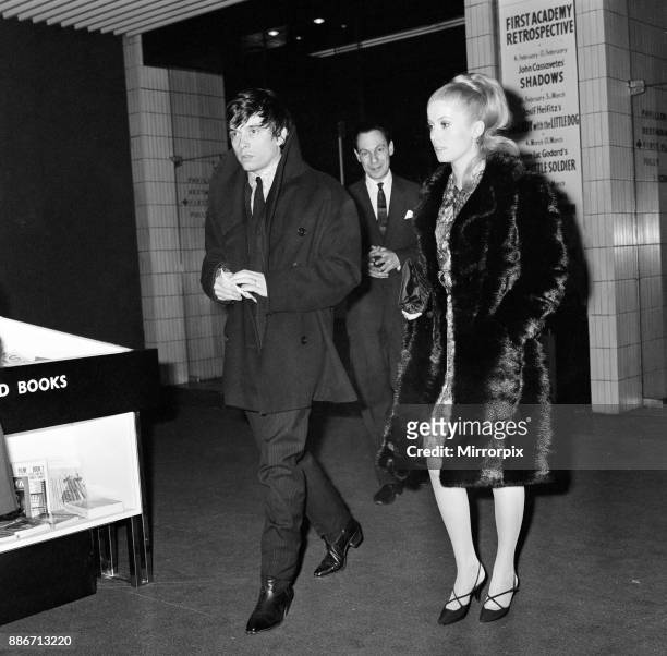 Catherine Deneuve, actress, and husband fashion photographer David Bailey arrive at the London premier of the Federico Fellini film 'Juliet of the...