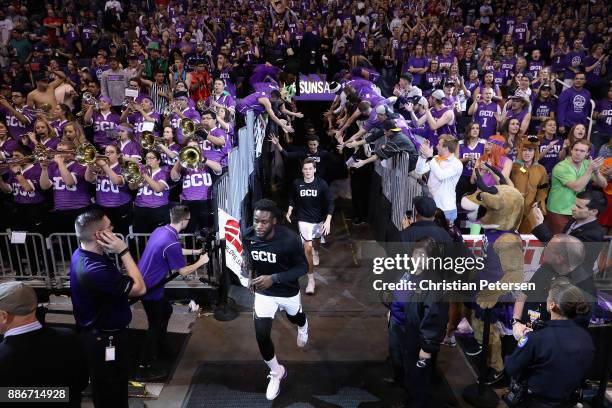 Fiifi Aidoo of the Grand Canyon Antelopes leads teamamtes onto the court before the college basketball game against the St. John's Red Storm at...