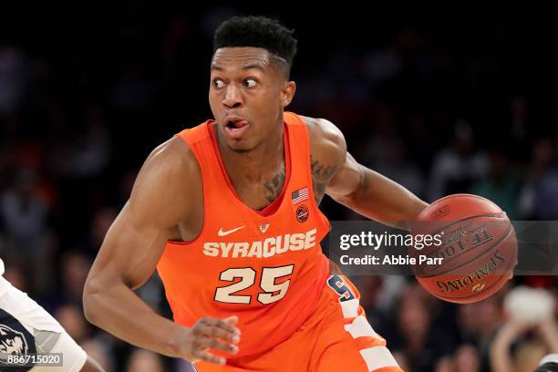 Tyus Battle of the Syracuse Orange drives down the court in the second half against the Connecticut Huskies during their game at Madison Square...