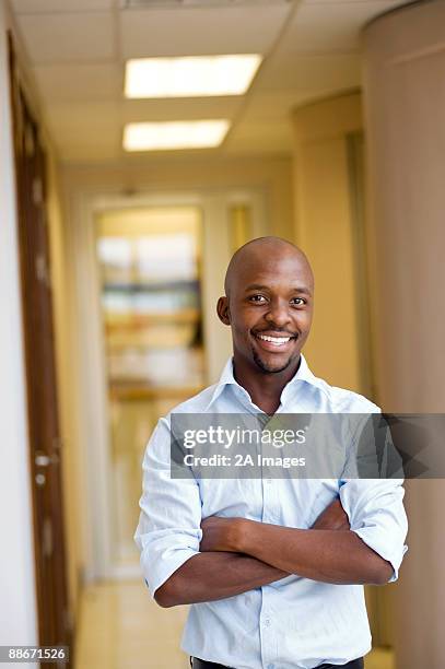 portrait of a businessman with rolled up sleeves in an office. pretoria, south africa - sleeve roll stock pictures, royalty-free photos & images