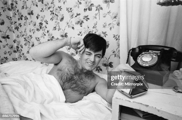 Tony Blackburn, the 22 year old Disc Jockey, in bed at his Knightsbridge flat, as his alarm call rings at 5am to wake him up. The girl who's ringing...