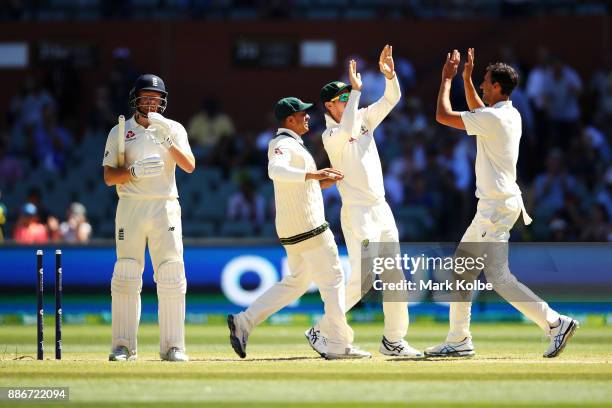 Jonny Bairstow of England looks dejected as Usman Khawaja, Cameron Bancroft and Mitchell Starc of Australia celebrate his wicket giving them victory...