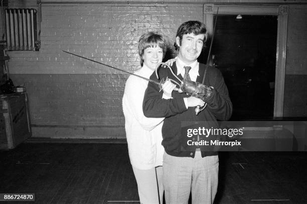 Maggie Smith in the title role of Peter Pan with Dave Allen as Captain Hook. Pictured together during rehearsals, 30th November 1973.